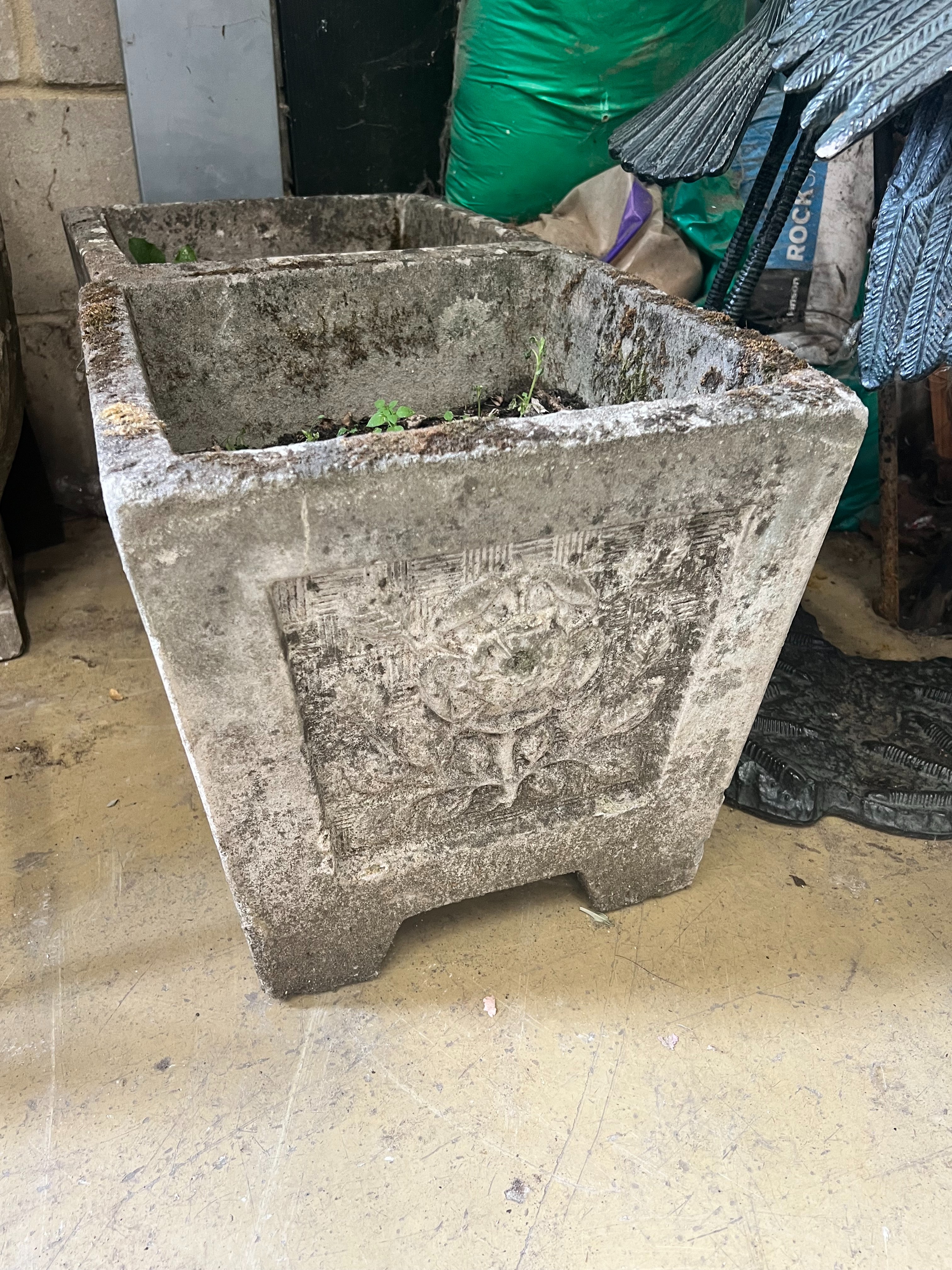 A pair of reconstituted stone square planters with rose motif, width 37cm height 36cm